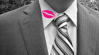 Pink lipstick kiss mark on man's white shirt collar