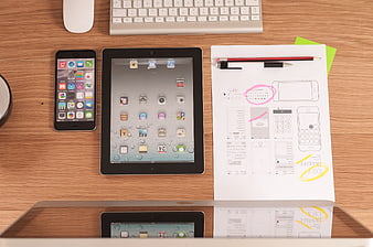 Flat lay of digital devices and UI design sketches on wooden desk