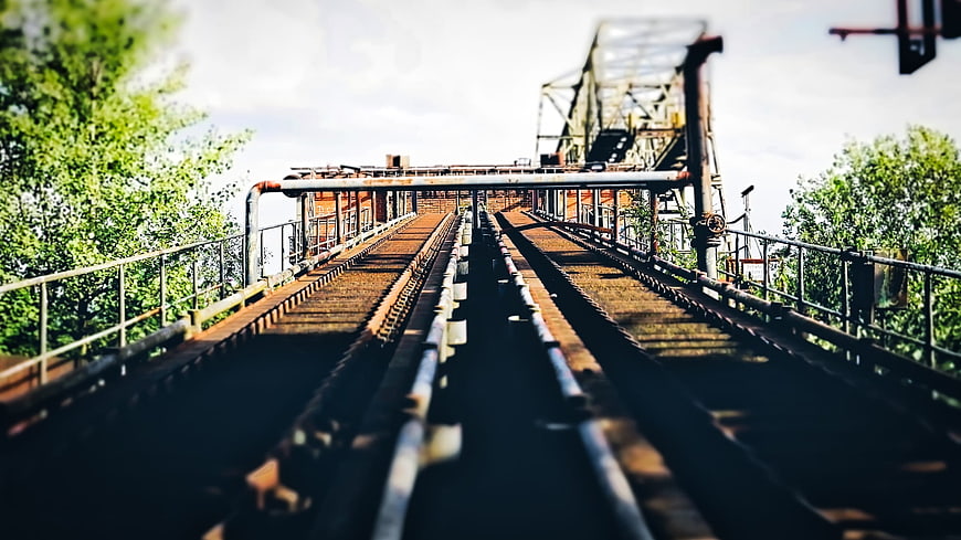 Abandoned industrial conveyor belts leading to mining structure