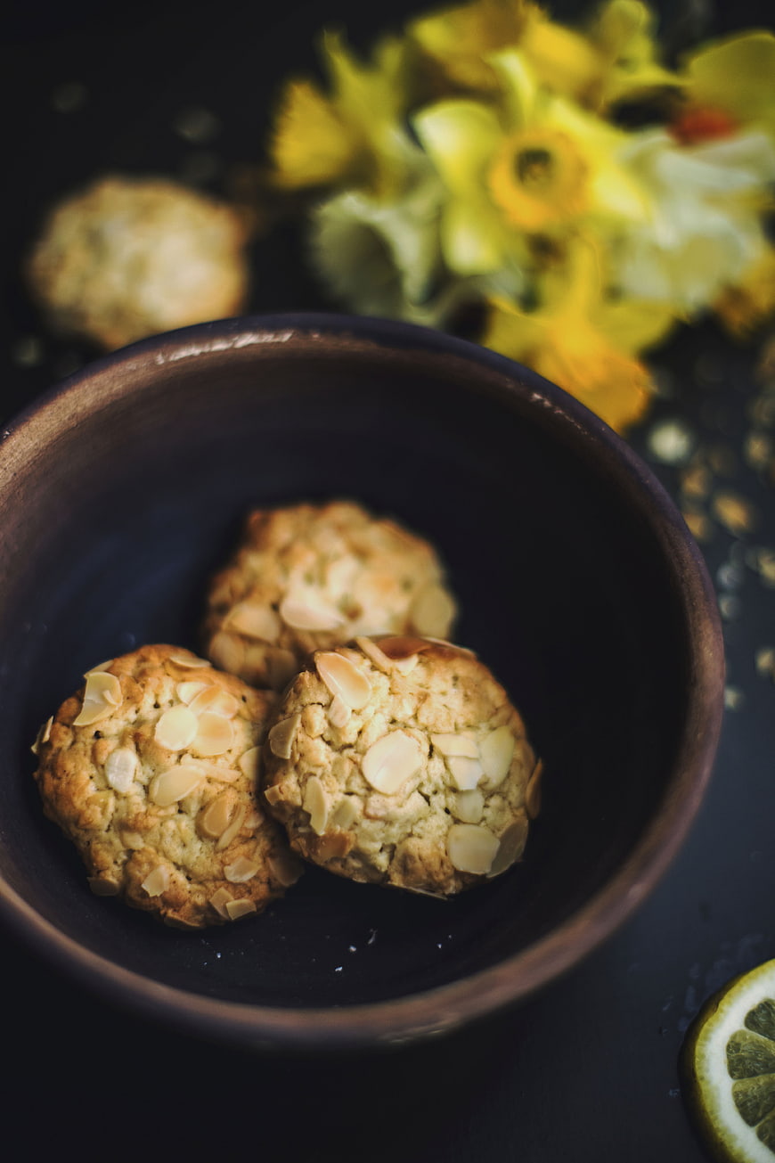 Almond Cookies in Dark Bowl with Yellow Flowers