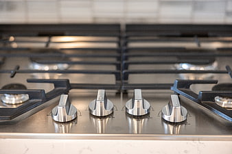 Close-up of modern stainless steel gas stove knobs