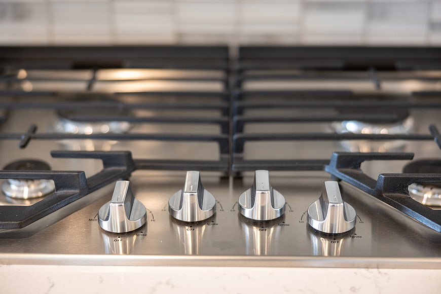 Close-up of modern stainless steel gas stove knobs