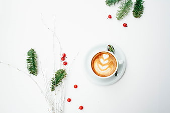 Flat lay of cappuccino with latte art and Christmas decorations