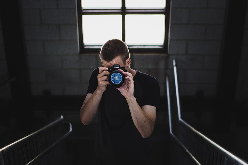 Male Photographer Taking Photo with DSLR Camera