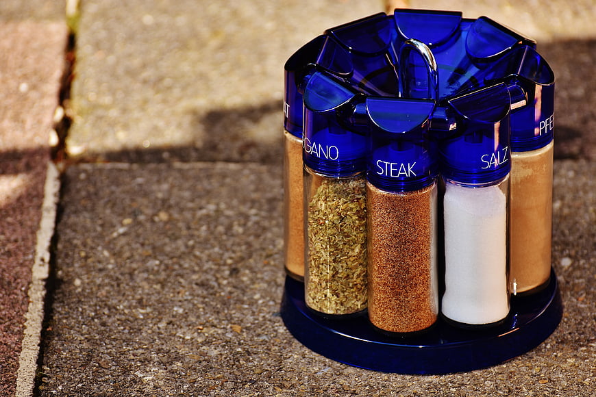 Blue Spice Rack with Seasonings on Outdoor Paving Stones