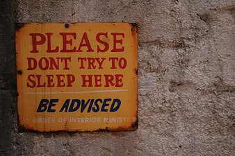 Vintage Warning Sign on Textured Concrete Wall