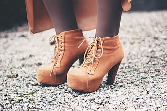 Woman Wearing Tan Suede Platform Heel Boots On Gravel