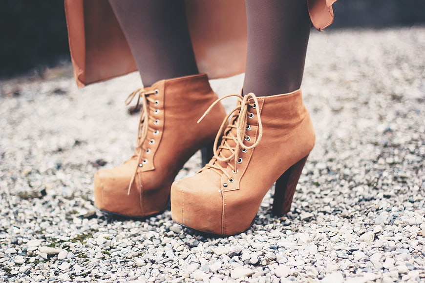 Woman Wearing Tan Suede Platform Heel Boots On Gravel