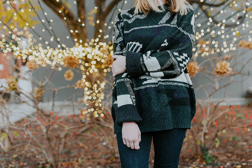 Woman in Oversized Patterned Sweater with Bokeh Lights