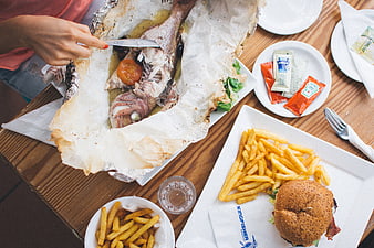 Top view of grilled whole fish and burger meal