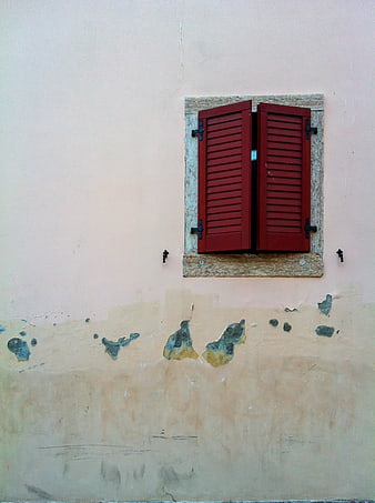 Red Shutters on Weathered Pink Wall
