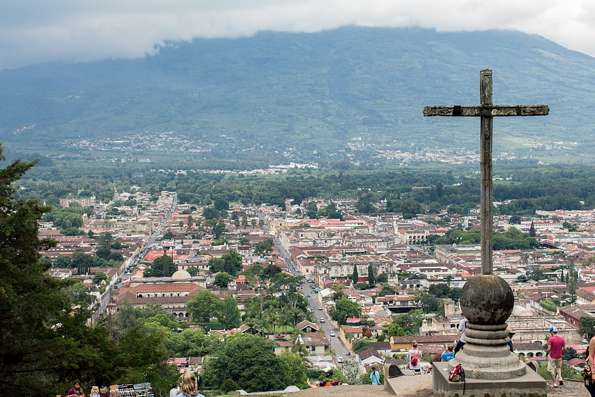 Stone Cross Overlooking Antigua Guatemala Cityscape and Volcanic Mountain