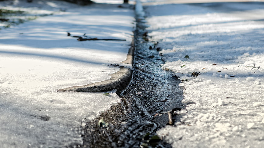 Melting Snow and Ice on a Winter Sidewalk