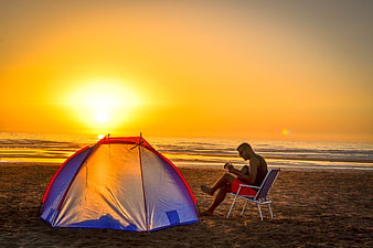 Man Playing Guitar On Beach At Sunset Near Tent
