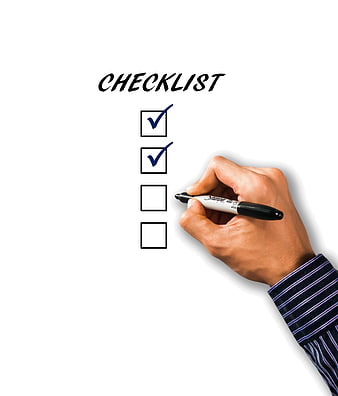 Hand Checking Off Items on a Business Checklist