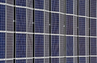 Close-up pattern of blue solar panels and silver frames