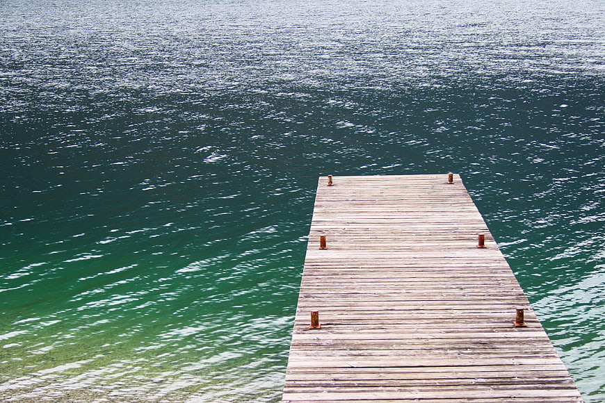 Wooden Dock Extending into Green Water