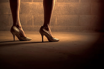 Woman's Legs in Gold Glitter High Heels