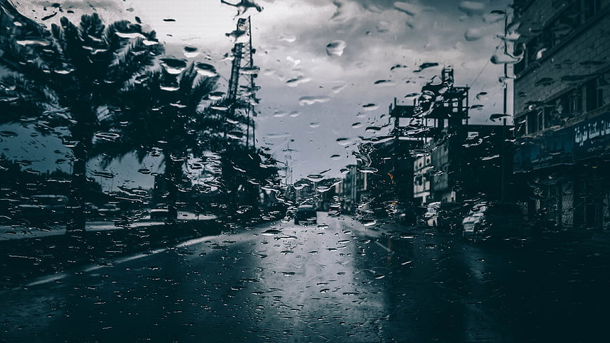 Rainy City Street View Through Wet Car Windshield