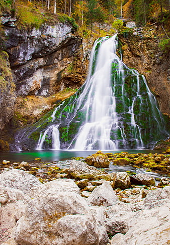 Mossy Waterfall Cascading Over Rocks In Autumn Forest