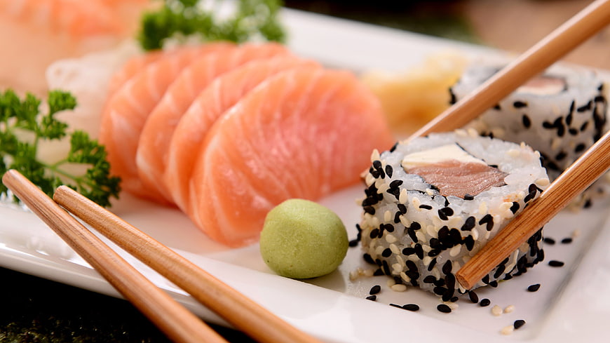 Fresh Salmon Sashimi and Sushi Rolls with Chopsticks