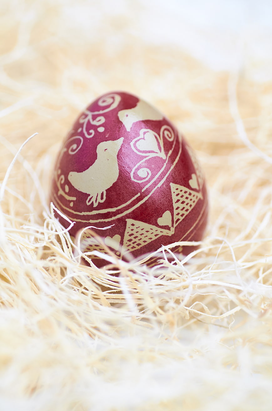 Hand-painted Easter egg in a nest of straw