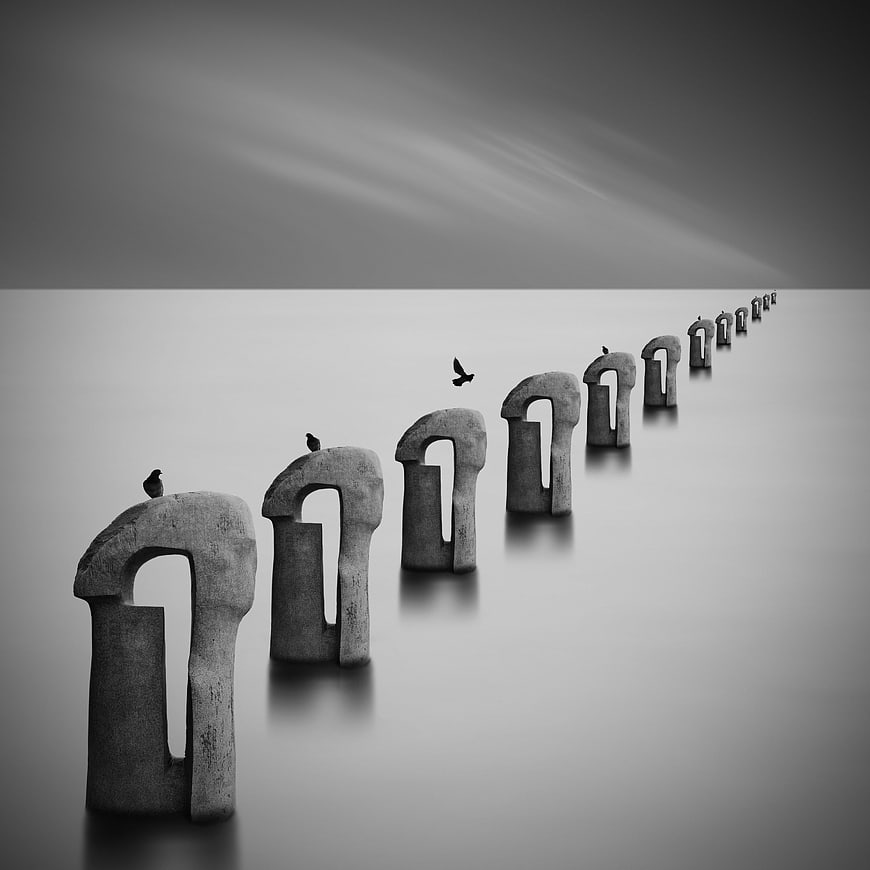 Abstract black and white stone arches in foggy landscape