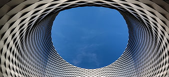 Abstract architectural spiral looking up at blue sky
