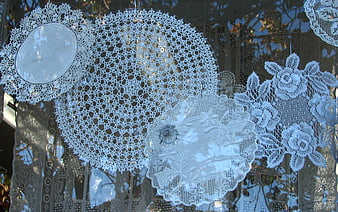 Vintage White Lace Doilies Hanging in Window Display