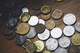 Scattered Polish Zloty Coins on Wooden Table