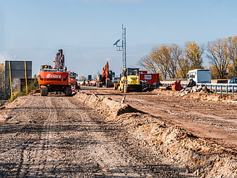 Heavy machinery at highway construction site with excavators