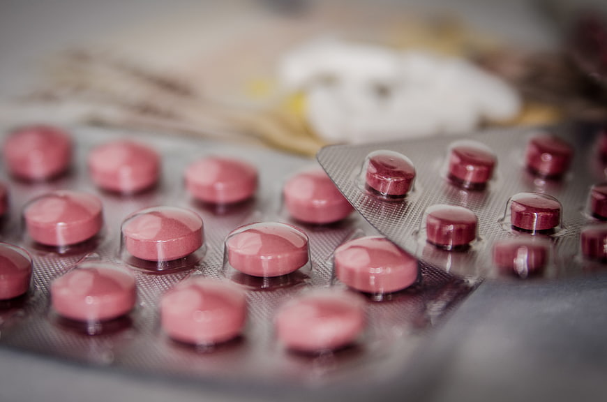 Close-up of pink and red pills in blister packs