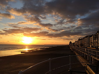 Golden Sunset Over English Seaside Promenade and Beach