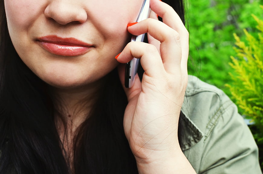 Close-up of woman talking on smartphone outdoors