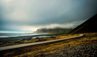 Winding Coastal Road Along Black Sand Beach in Iceland