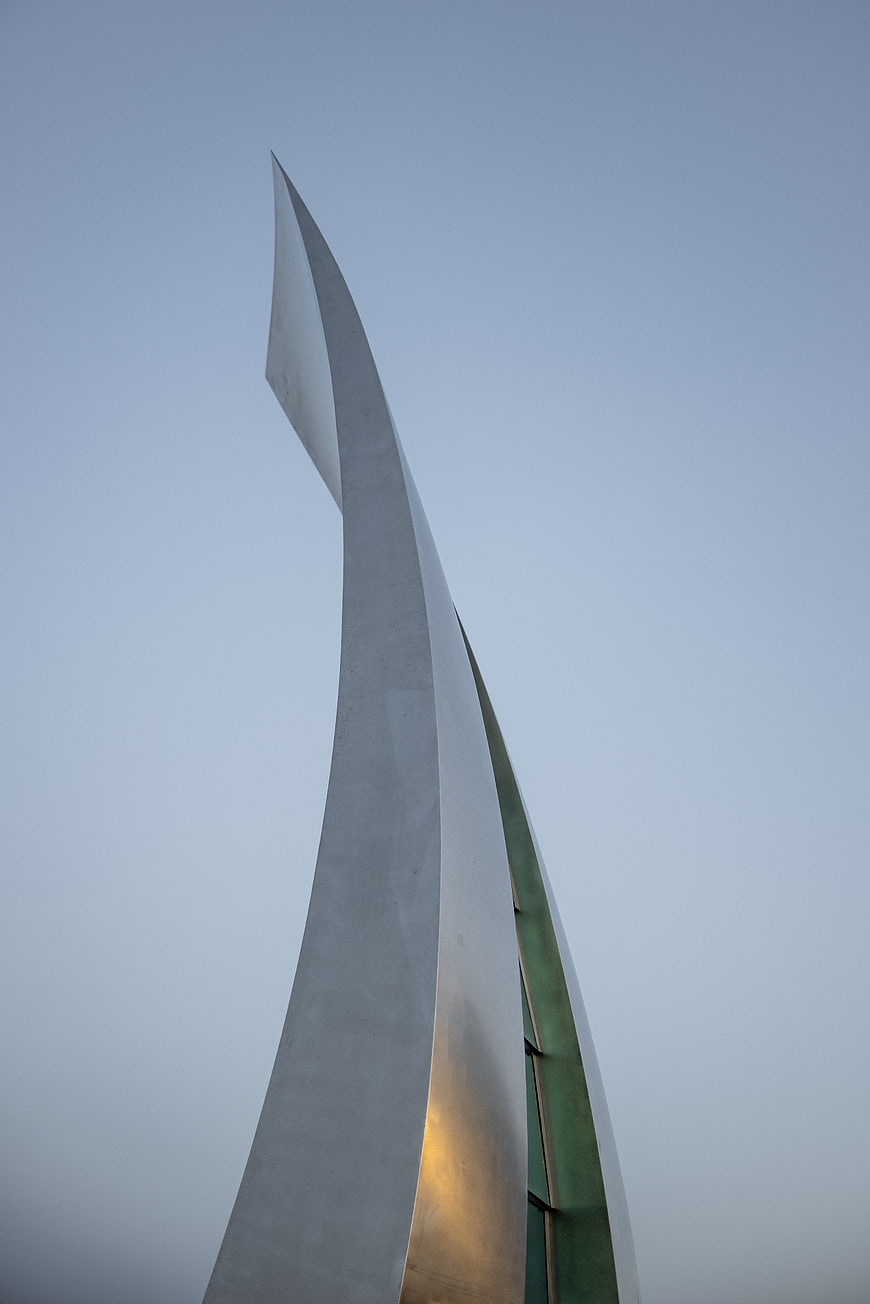 Modern Abstract Metal Sculpture Against Blue Sky
