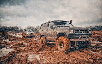 Muddy Off-Road SUVs Navigating Challenging Terrain