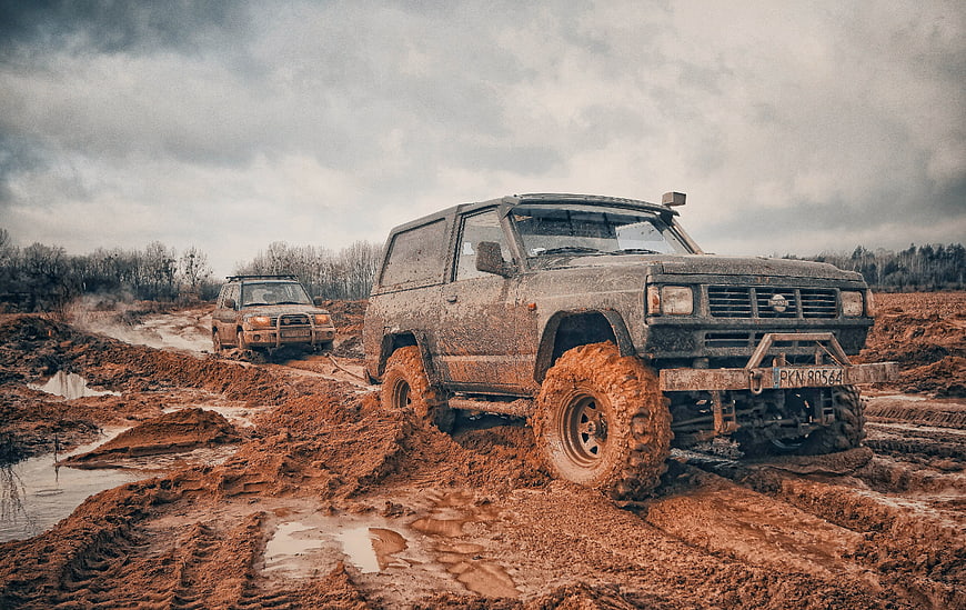 Muddy Off-Road SUVs Navigating Challenging Terrain