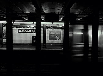 Black and white photo of Nassau Avenue subway station with moving train