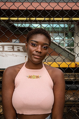 Portrait of stylish Black woman with pink eyeliner and floral top