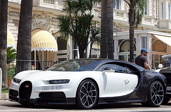 White Bugatti Chiron Super Car Parked On Street In Front Of Hotel
