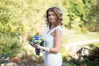 Bride with Blue Bouquet in Garden