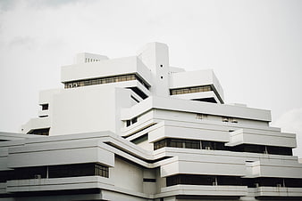 Modern White Geometric Architecture Against Overcast Sky