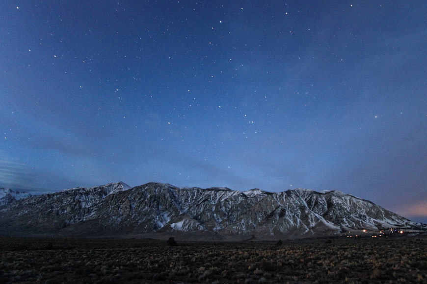 Snowy Mountain Range Under Starry Night Sky