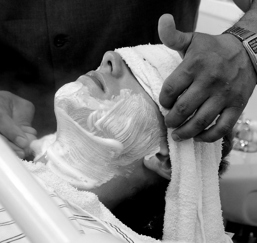 Close-up of man getting traditional wet shave with shaving cream