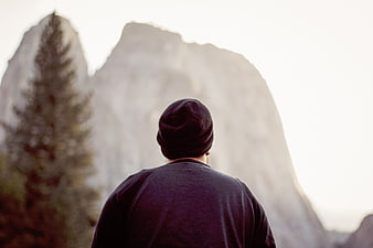 Man in Beanie Looking at Mountain Landscape