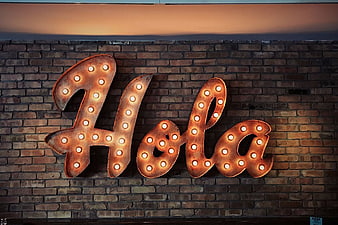 Retro Marquee Hola Sign on Brick Wall