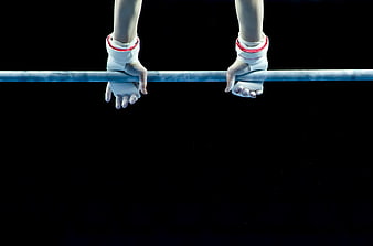 Gymnast Hands Gripping Uneven Bars on Black Background