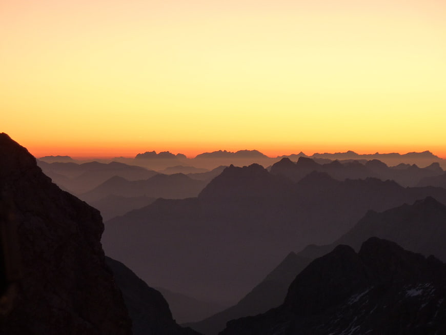 Silhouette of mountain ranges at sunrise with atmospheric perspective