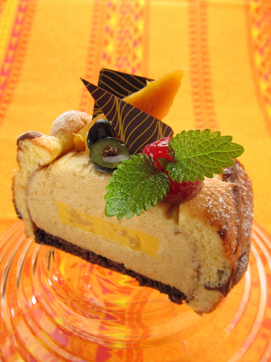 Exotic Mango Cheesecake Slice with Fresh Fruit Garnish